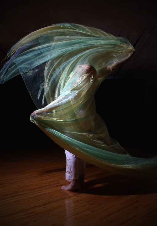 Dancer Chase Booth wraps himself in multicolor fabric. 